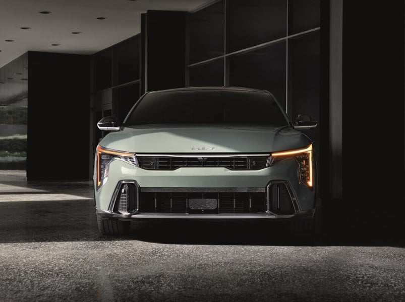 Front view of Kia K4 parked next to building entrance from Kia Dealer near Dublin OH